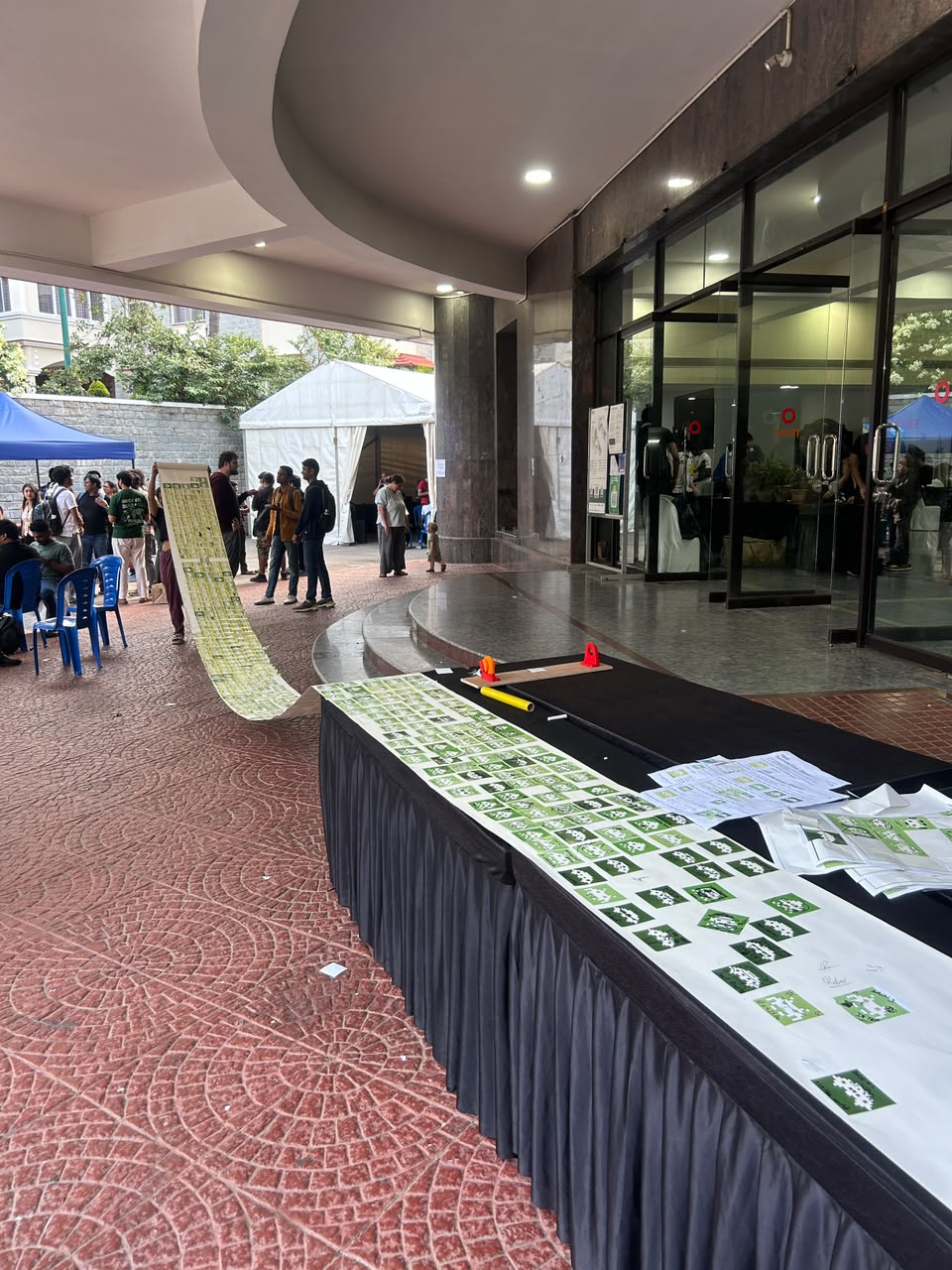 The scroll unrolled along a table at the IndiaFOSS venue, people walking past.